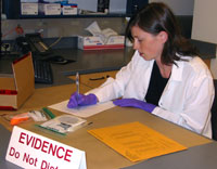 In her role as evidence analyst, Angi Christensen examines evidence in an area of restricted access.
