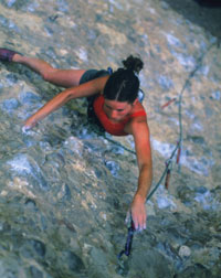 Angi Christensen scales a nearly vertical rock, an activity she enjoys on weekends.
