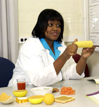 Antoinette teaches a patient about proper nutrition and healthy eating habits.