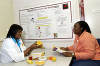 Antoinette and a patient discussing the benefits of the DASH diet.