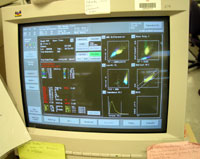 Cell counter test results are displayed on a computer monitor.