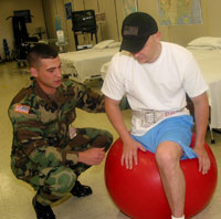 Chris Weaver uses a physio-ball to help improve a patient's balance and stability.
