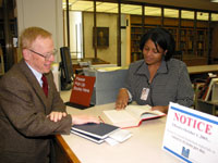 Crystal Smith helps a National Library of Medicine customer at the reference desk.