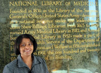 Crystal Smith stands in front of the National Library of Medicine.