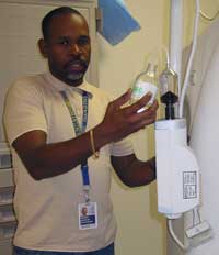 Dennis Johnson prepares an intravenous solution that provides image contrast for CT scans to highlight a patient's organs and vessels.