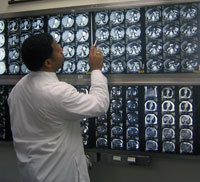 Derrick Cox analyzes a pre-operative MRI scan before surgery.