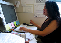 Faith works on her computer searching other public databases for gene variants and analyzing data from completed experiments.