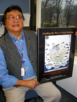 Frank GrayShield, M.P.H., holds a poster that commemorates the American Indian and Alaska Native Heritage Month observed in November 2001.