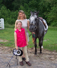 Gloria Stables, with her daughter and horse at a riding competition