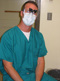 James Tynecki wears protective eye gear with magnifying glasses when working with patients.
