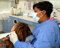 Dr. Cyriaque examines a dental patient.