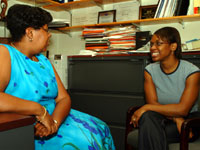 Dr. Cyriaque meeting with one of her students in her office.