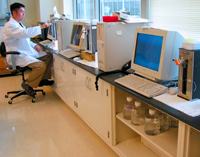 Joel uses one of a long row of machines designed to mechanically shear DNA samples for further processing.