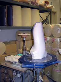 The set-up shown is one step in the process of making a prosthetic device. The plaster model of a patient’s limb is covered with a clear plastic cuff held in place by a vacuum.