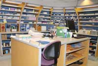 Drug orders are processed in a room (as pictured) that is filled with shelves containing various drugs.