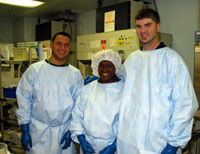 Leslie stands with colleagues in the laboratory
