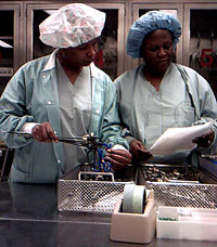 Lisa Brown and her colleague, Dina Adu, perform and inventory on endoscopic instruments they will need for a surgery the following day.