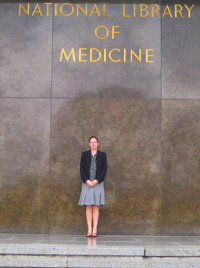 Manon standing at the entrance of the National Library of Medicine in Bethesda, Maryland.
