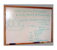 This dry erase board is covered with complex mathematical computations typically used in biostatistical studies.