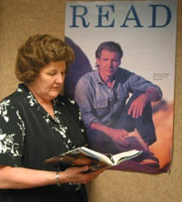 Robin Meckley with a poster of her favorite actor, Harrison Ford, who shares her love of reading.