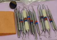 As shown here, typical instruments that Sherri Gollins uses to examine the oral environment include scalers, currettes, explorers and probes.