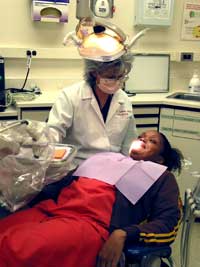 Sherri Gollins examines a patient.