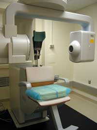 The imaging machine shown creates 3-dimensional radiographs of a patient's head and neck region.
